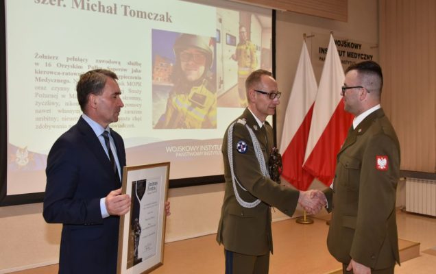 Michał Tomczak odbiera nagrodę Animus Fortis z rąk dyrektora Wojskowego Instytutu Medycznego