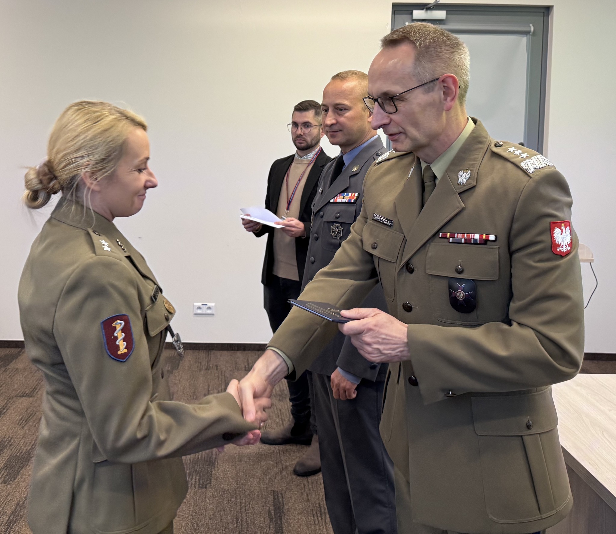 Inauguracja studiów podyplomowych w WIM-PIB. Dyrektor Grzegorz Gielerak wręcza dyplom studencki.