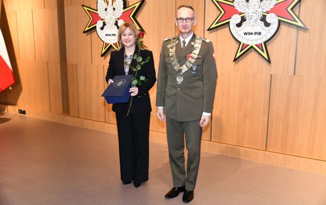 Dyrektor WIM pozuje z doktor Agnieszką Rustecką trzymającą nagrodę oraz czerwoną różę