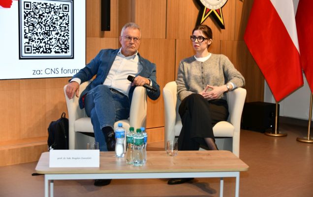 Prelegenci siedzący w fotelach podczas jednego z paneli.