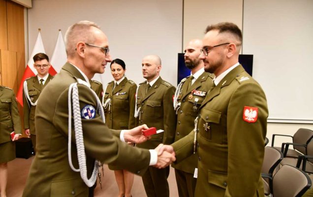 Dyrektor WIM wręcza odznaczenie.