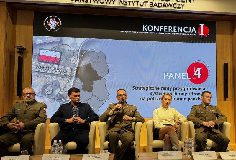 Dyrektor WIM Grzegorz Gielerak siedzi obok panelistów. Za nimi na ekranie plansza tytułowa panelu.